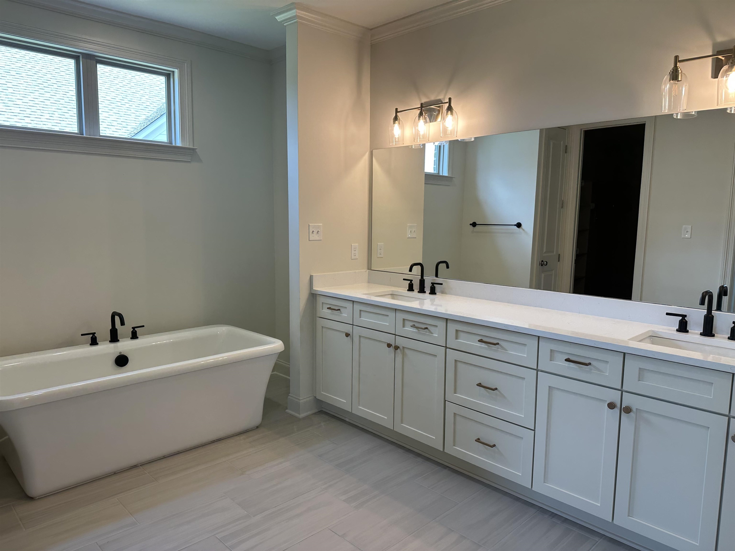 11512 Sunsparkler Way Collierville, TN 38017 - Photo 5 of 9 a spacious bathroom with a double vanity sink mirror and bathtub