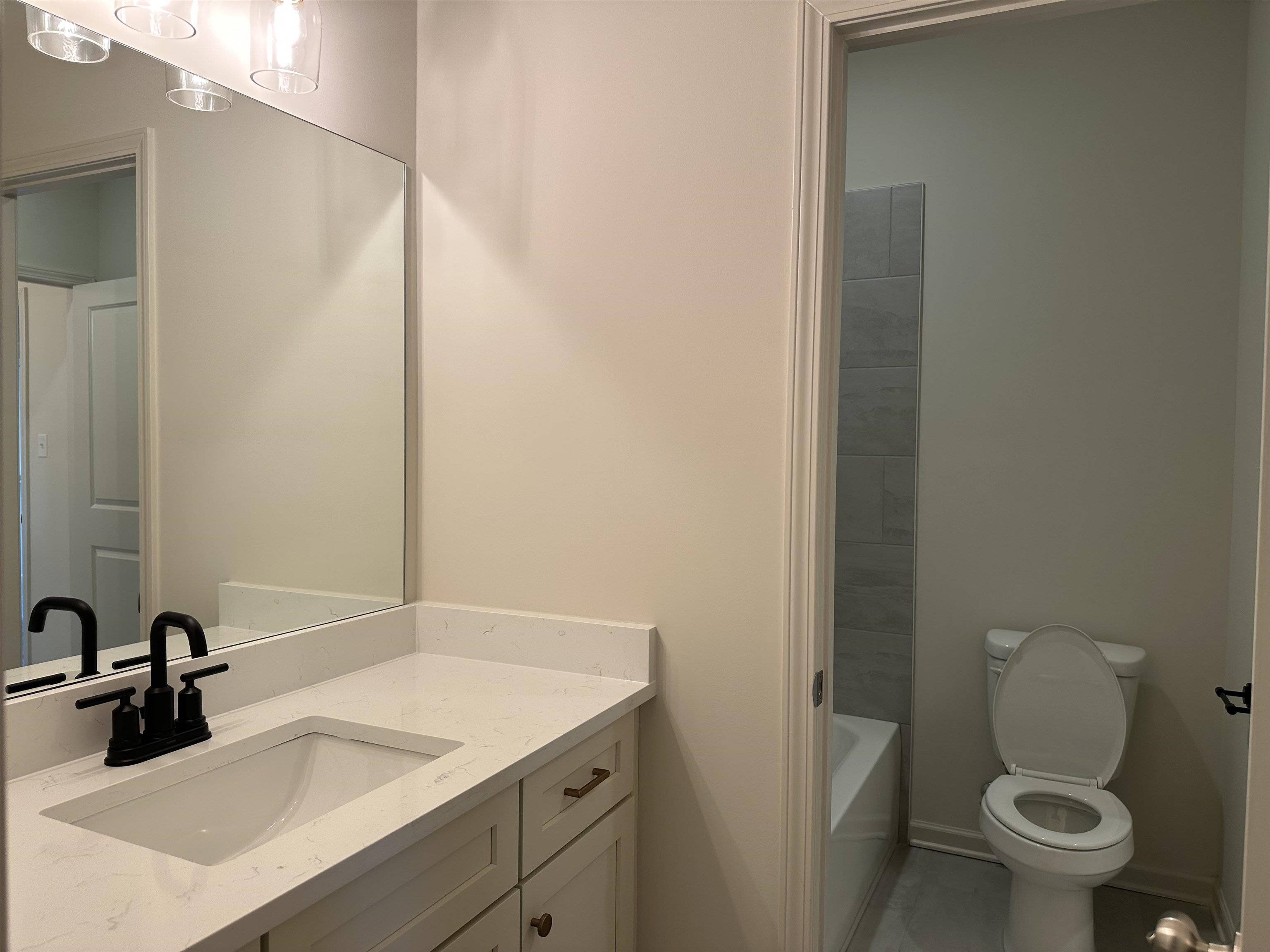 11512 Sunsparkler Way Collierville, TN 38017 - Photo 8 of 9 a bathroom with a granite countertop sink a toilet and a mirror
