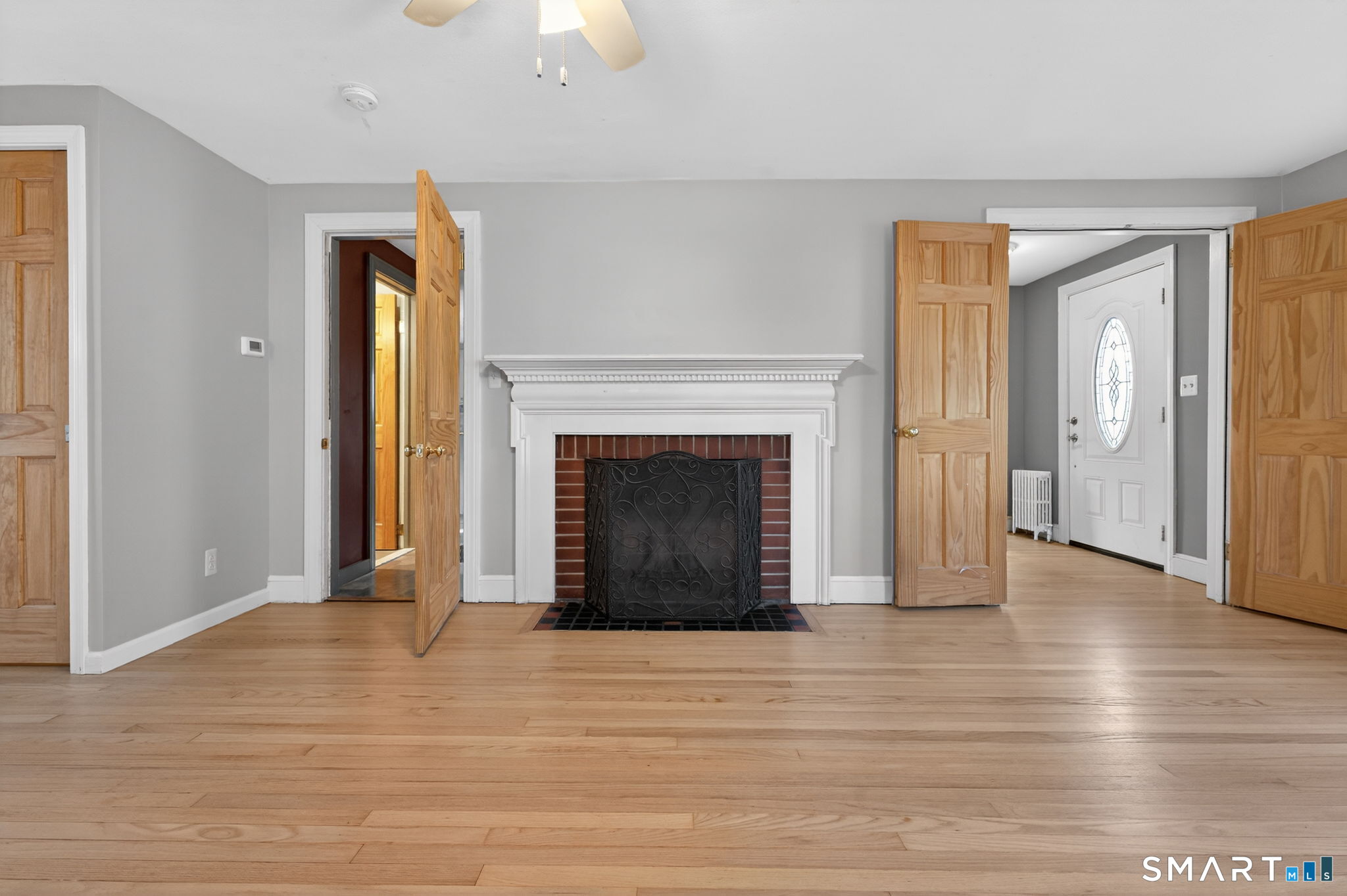32 Garvan Street Newington, CT 06111 - Photo 15 of 36 an empty room with wooden floor fireplace and windows