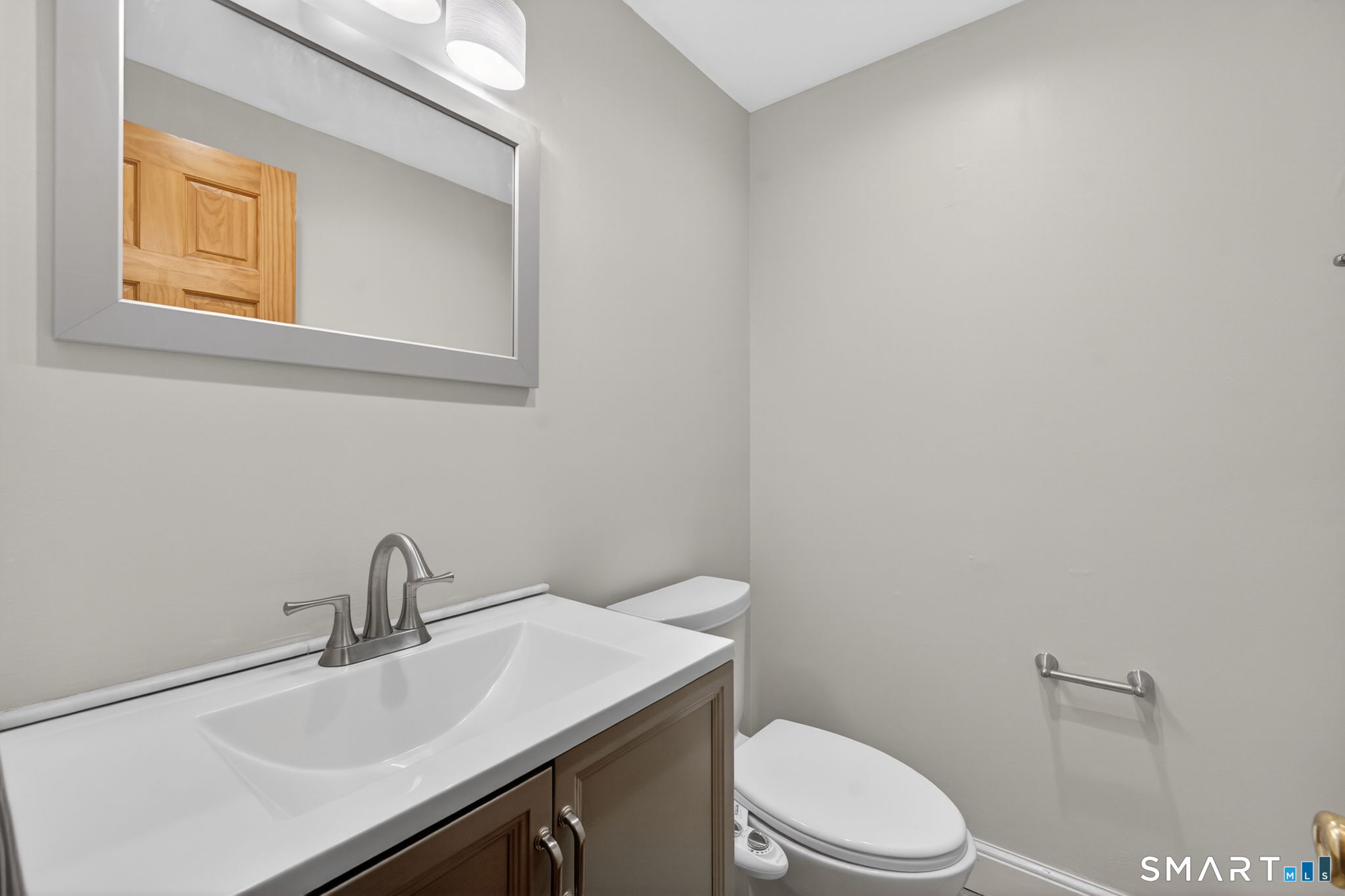 32 Garvan Street Newington, CT 06111 - Photo 16 of 36 a bathroom with a sink a toilet and mirror