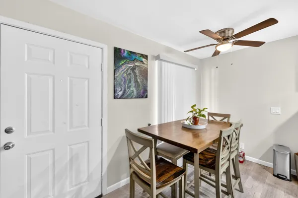 a view of a dining room with furniture and a chandelier fan