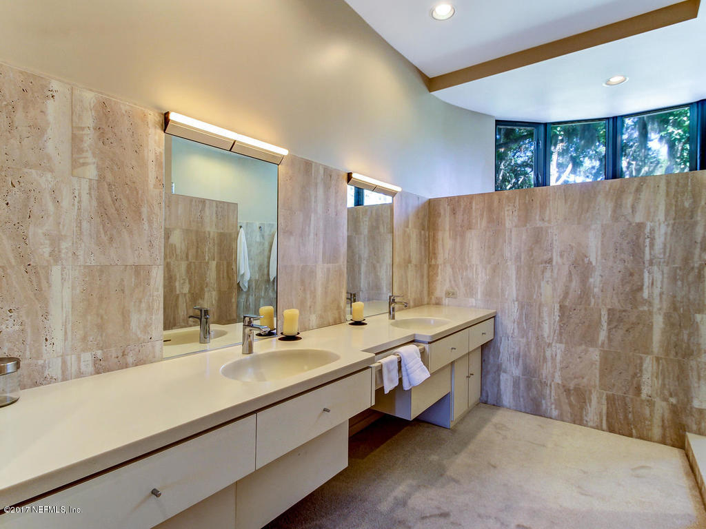 3039 Front Road Jacksonville, FL 32257 - Photo 42 of 71 a bathroom with double vanity sinks and a mirror