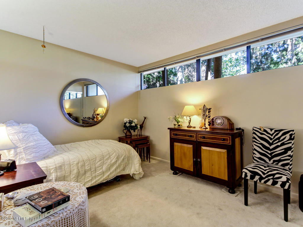 3039 Front Road Jacksonville, FL 32257 - Photo 53 of 71 a bedroom with a bed and a potted plant on the dresser