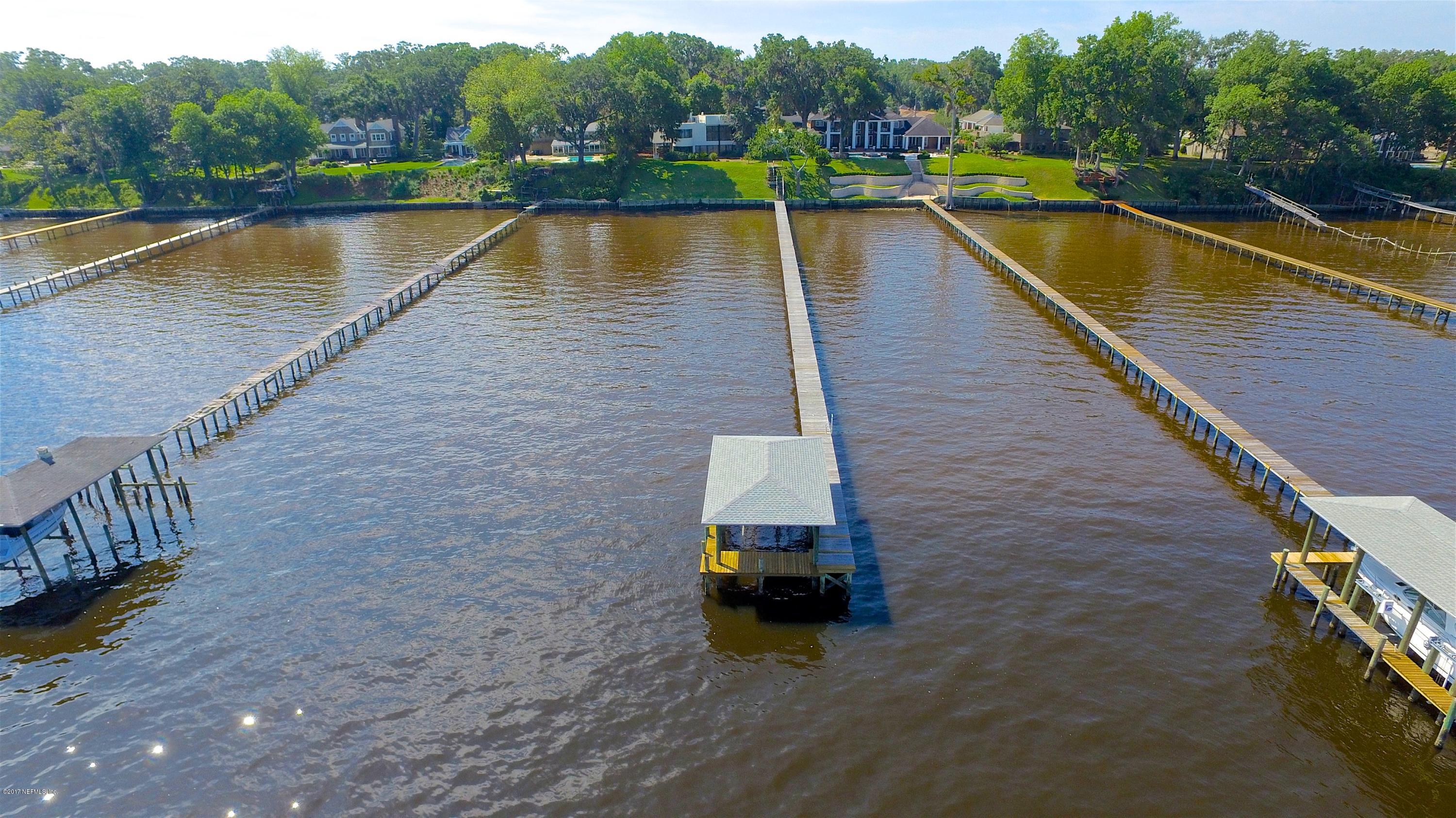3039 Front Road Jacksonville, FL 32257 - Photo 10 of 71 a view of a lake with a barbeque and wooden stairs