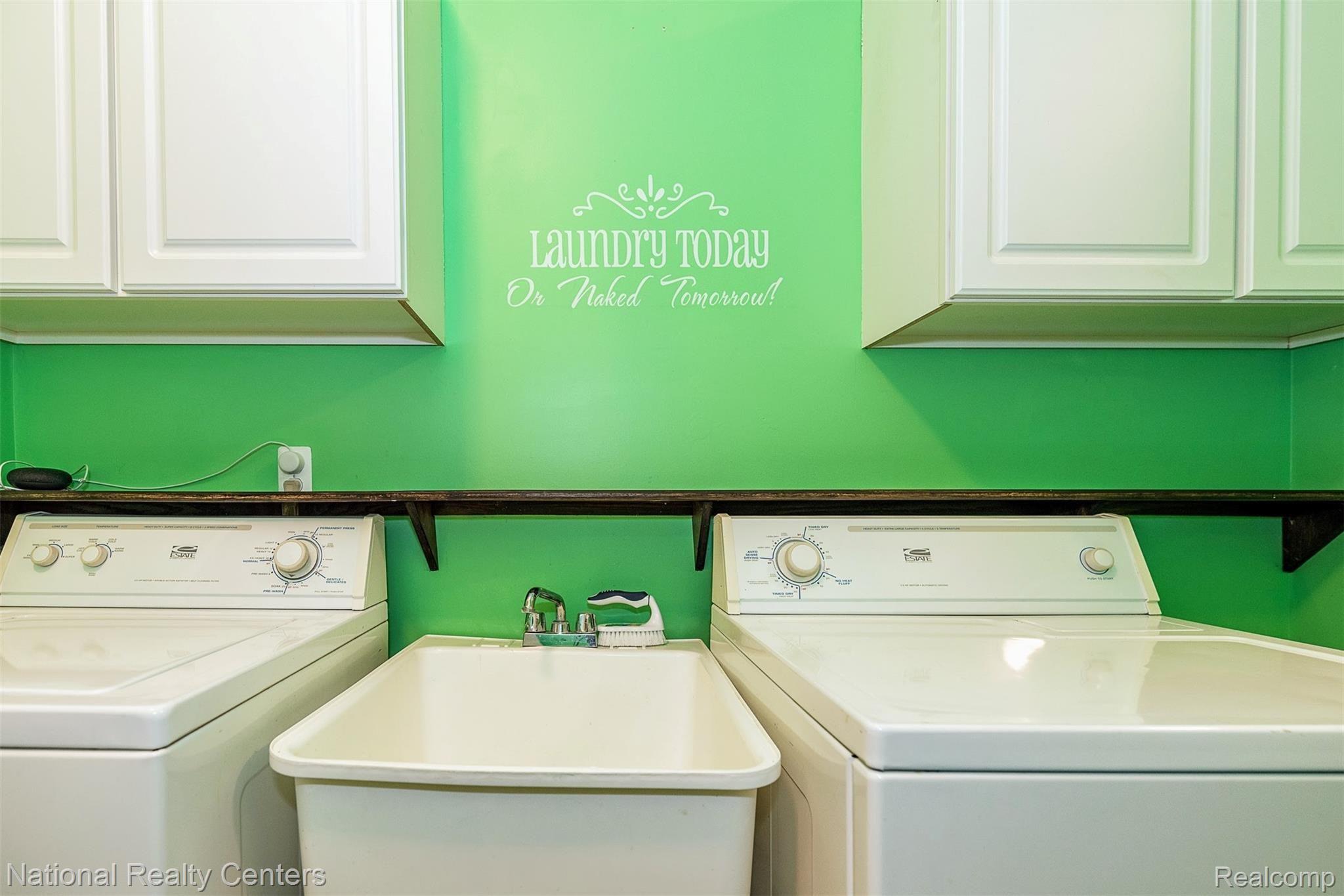 11740 Farmington Road Livonia, MI 48150 - Photo 28 of 31 Nice laundry room with tub, cabinet space. Washer and dryer stay.