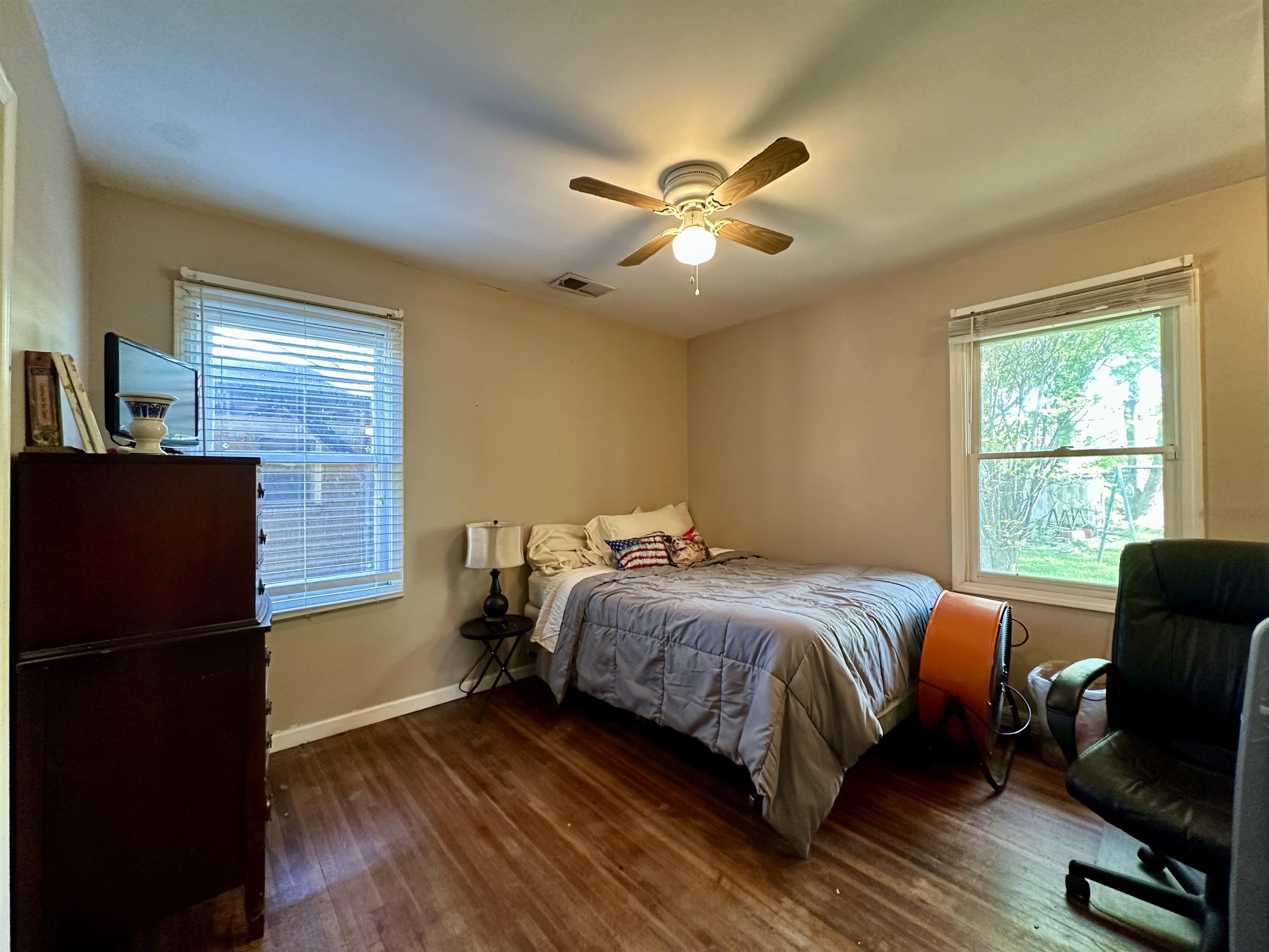 4544 Quince Road Memphis, TN 38117 - Photo 8 of 11 a bedroom with a bed and wooden floor