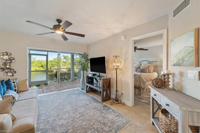 a living room with furniture tv and a flat screen tv