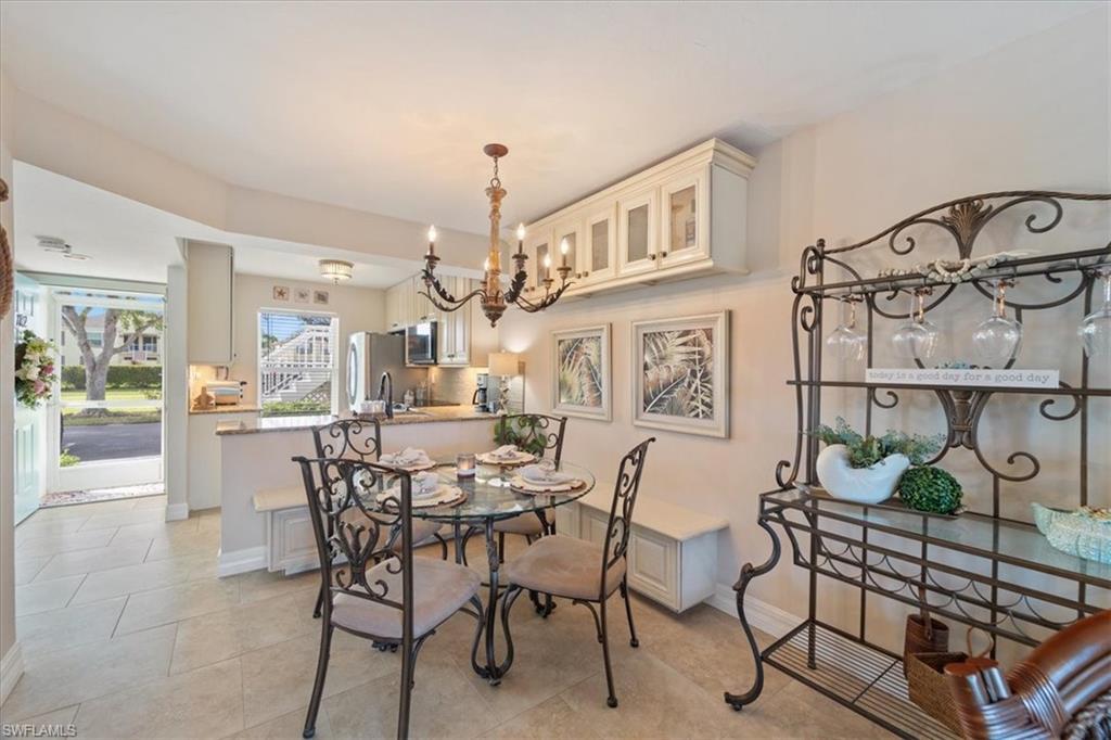 1375 Mainsail Drive, Unit 1702 Naples, FL 34114 - Photo 17 of 38 a view of a dining room with furniture