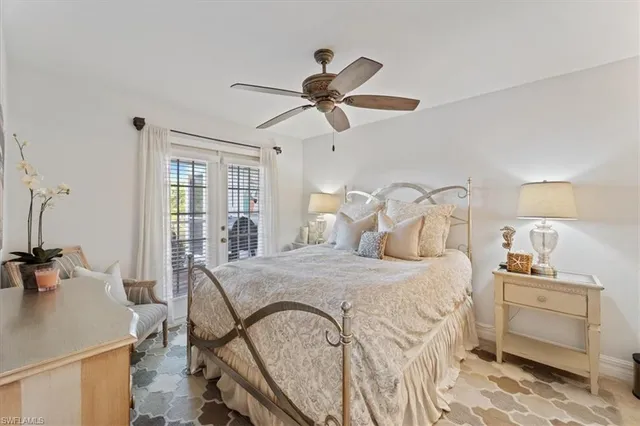 a bedroom with a bed and a table with the dresser