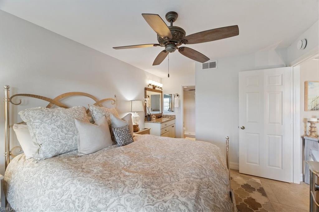 1375 Mainsail Drive, Unit 1702 Naples, FL 34114 - Photo 19 of 38 a bedroom with a bed and a painting on the wall