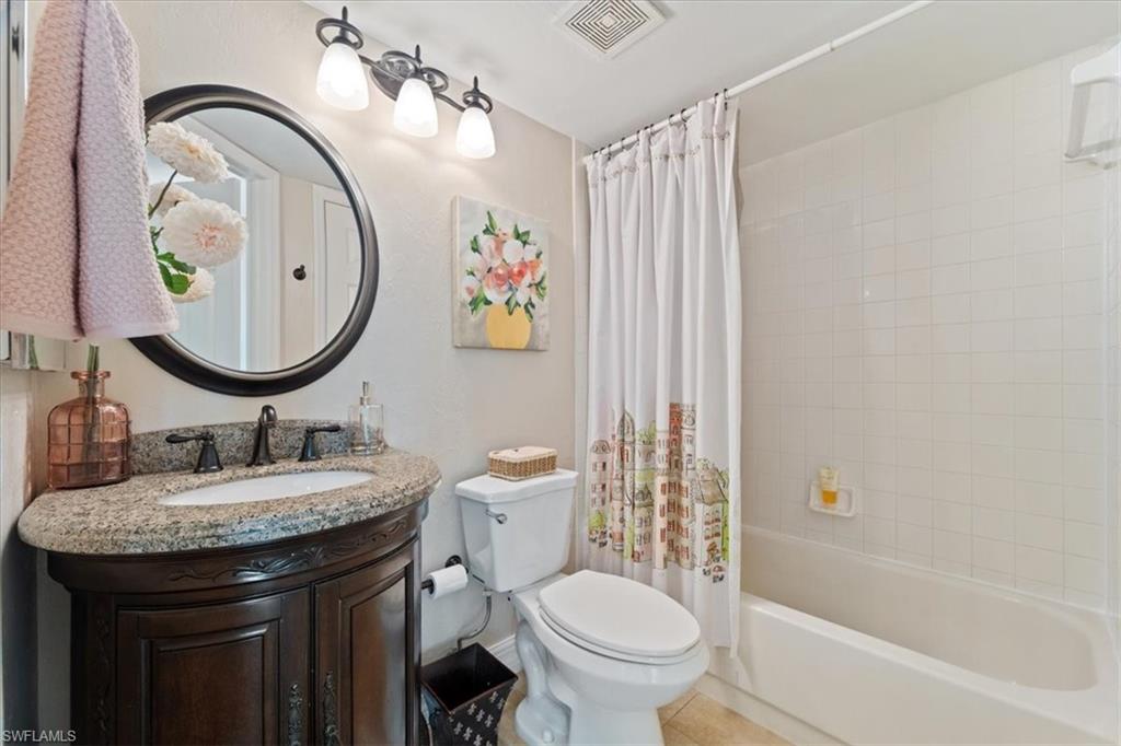 1375 Mainsail Drive, Unit 1702 Naples, FL 34114 - Photo 26 of 38 a bathroom with a sink and a mirror with toilet