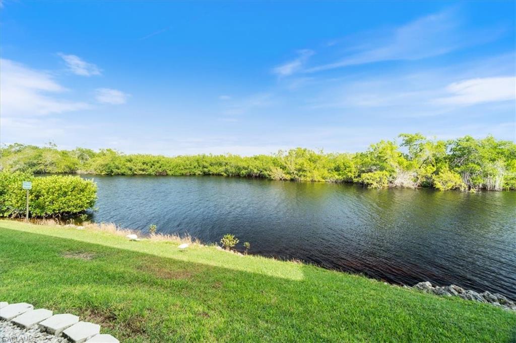 1375 Mainsail Drive, Unit 1702 Naples, FL 34114 - Photo 30 of 38 a view of a lake with a big yard