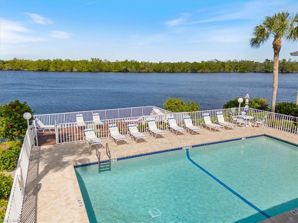1375 Mainsail Drive, Unit 1702 Naples, FL 34114 - Photo 3 of 38 a view of a lake with a mountain