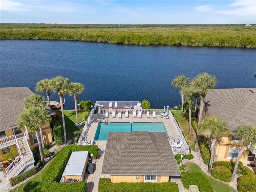 1375 Mainsail Drive, Unit 1702 Naples, FL 34114 - Photo 32 of 38 a view of swimming pool with a table and chairs