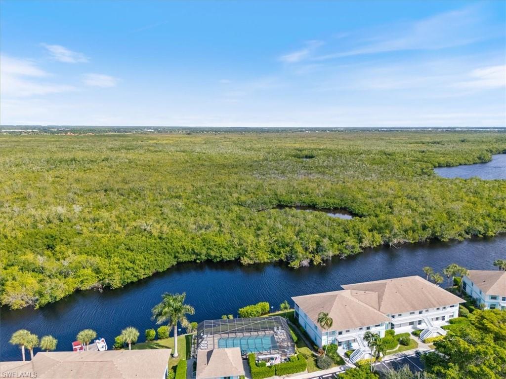 1375 Mainsail Drive, Unit 1702 Naples, FL 34114 - Photo 34 of 38 a view of a lake with a houses