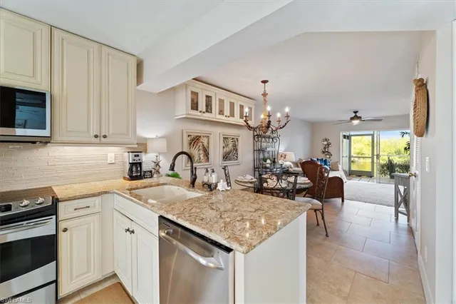 a kitchen with a sink a stove and cabinets