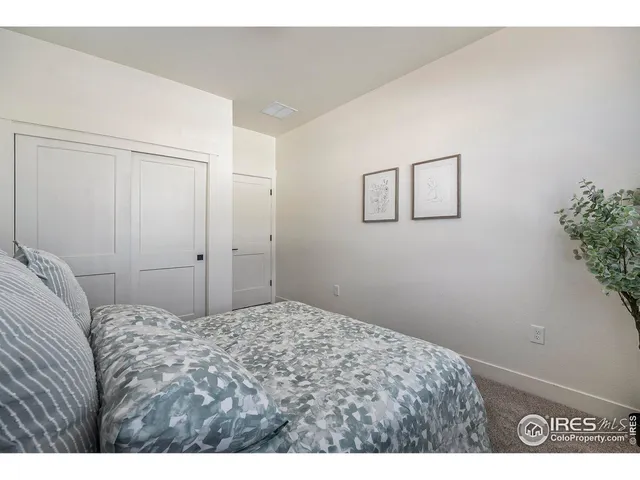 a bedroom with a bed and a potted plant