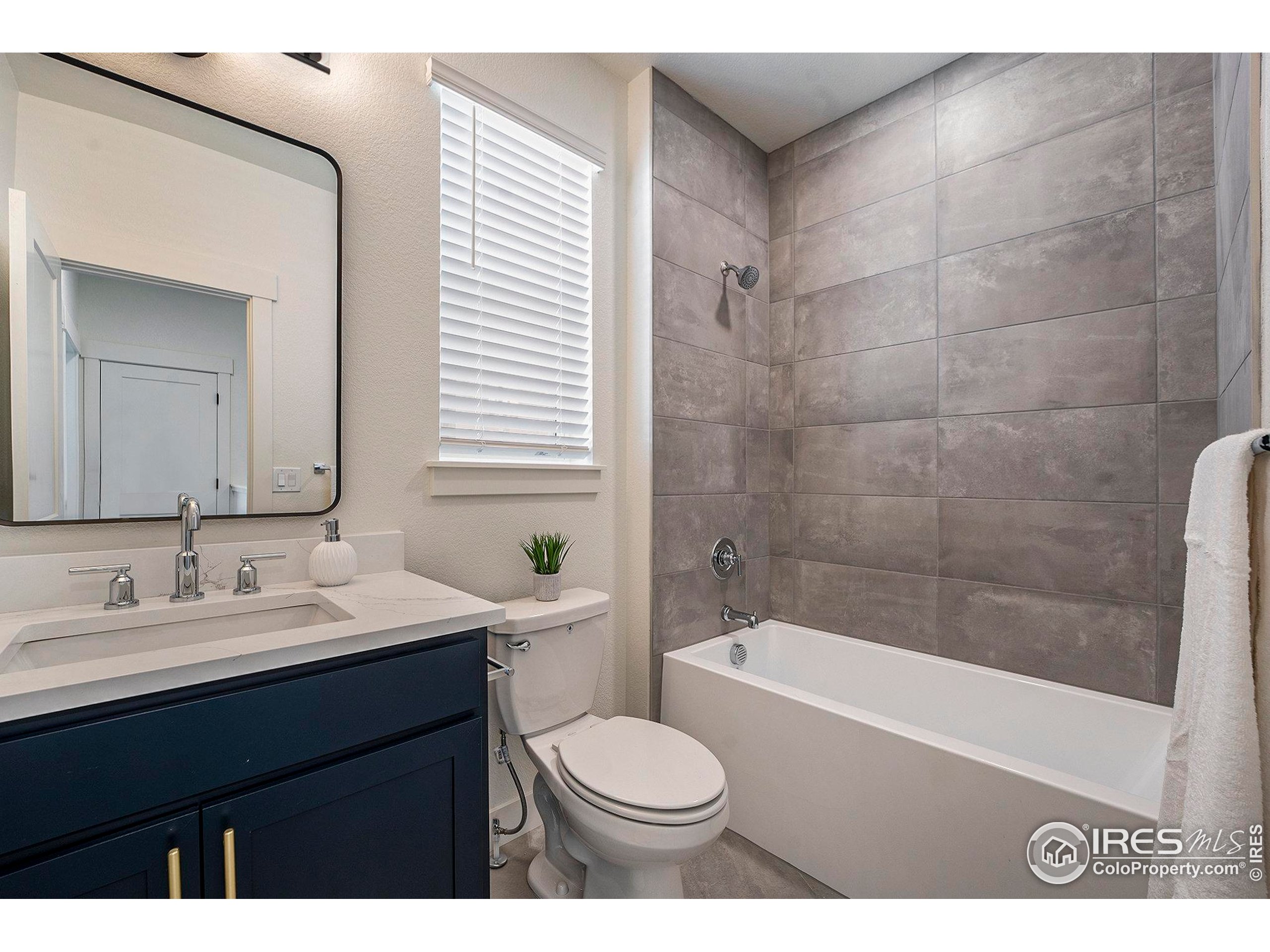 5001 Avon Avenue Loveland, CO 80538 - Photo 14 of 16 a bathroom with a sink a toilet and bathtub
