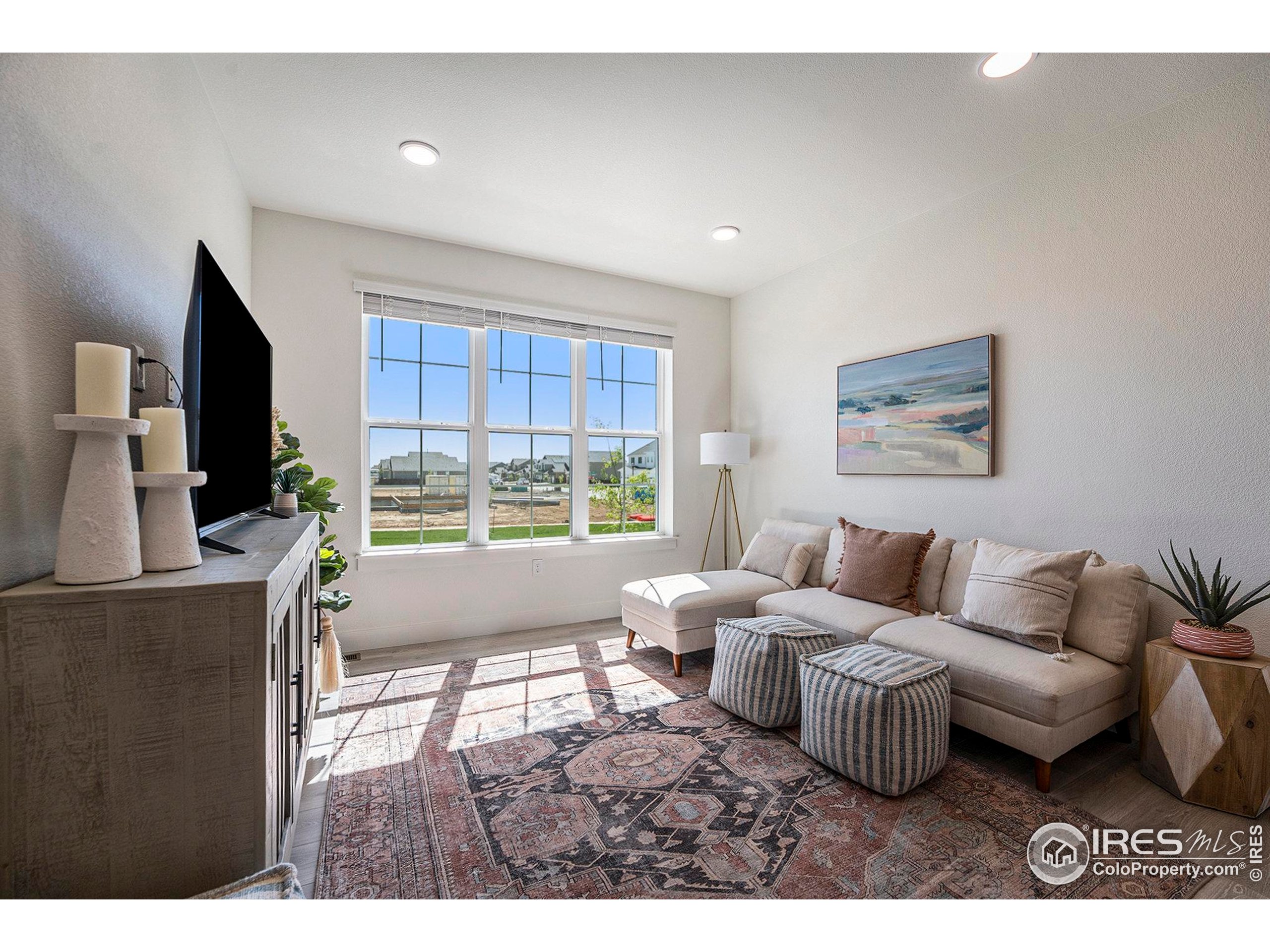 5001 Avon Avenue Loveland, CO 80538 - Photo 2 of 16 a living room with furniture and a flat screen tv
