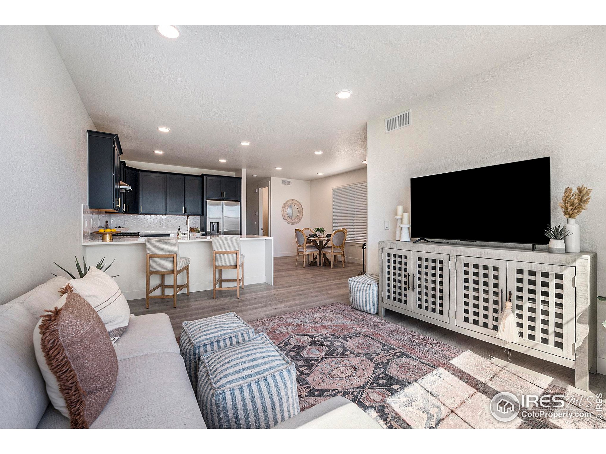 5001 Avon Avenue Loveland, CO 80538 - Photo 3 of 16 a living room with furniture and a flat screen tv