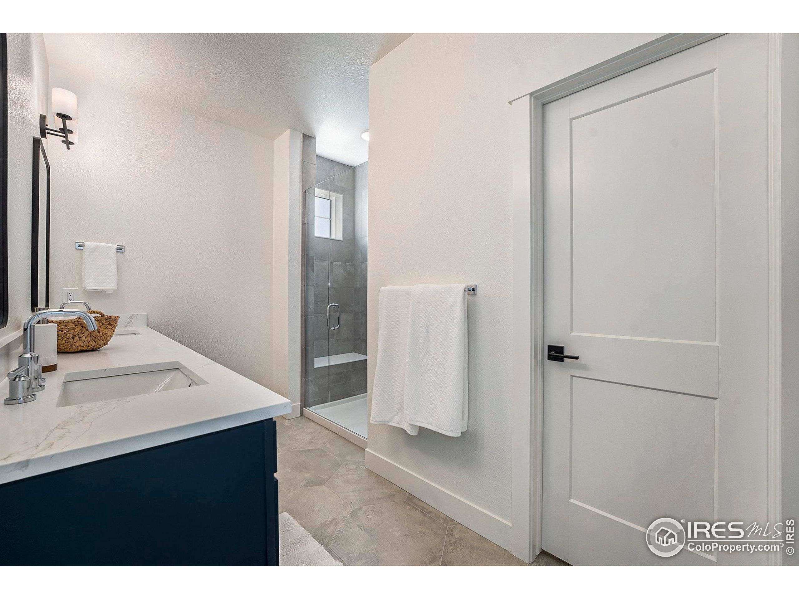 5001 Avon Avenue Loveland, CO 80538 - Photo 9 of 16 a bathroom with a sink vanity and a mirror