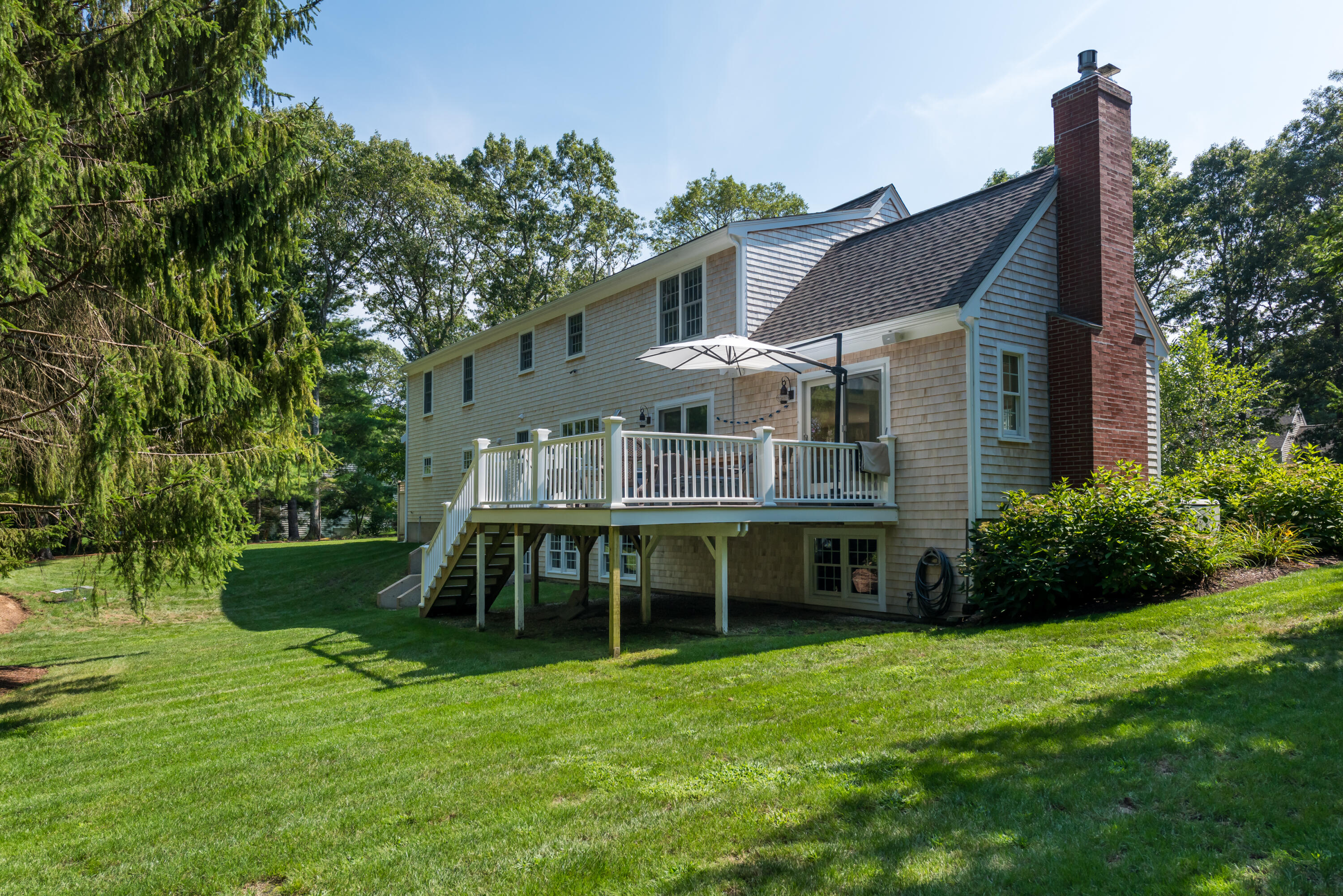 68 Tupelo Road Marstons Mills, MA 02648 - Photo 6 of 29 a front view of a house with garden
