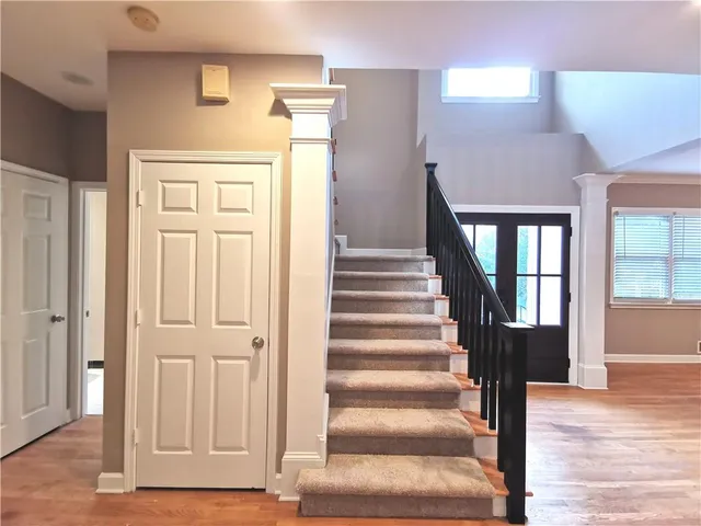 a view of entryway and hall with wooden floor