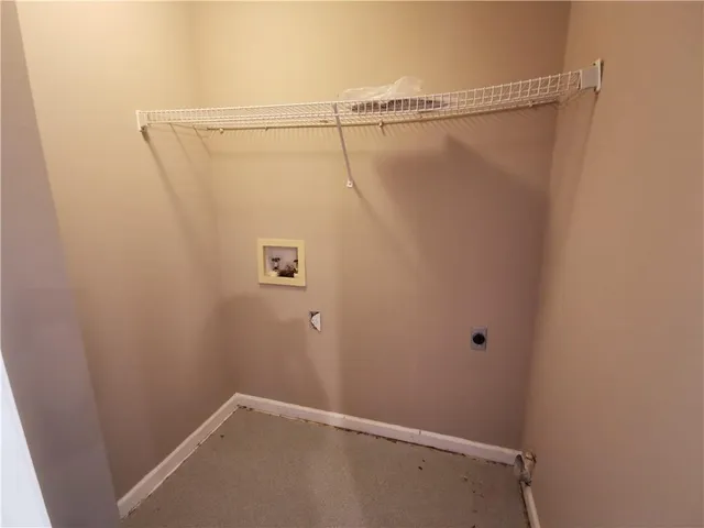 an empty room with a ceiling fan and window