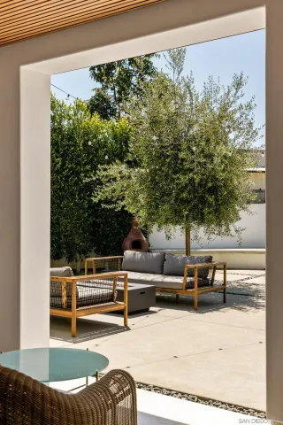 a backyard of a house with outdoor seating
