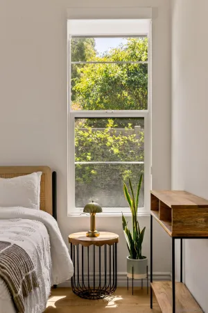 a bedroom with a bed and a window