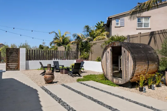 a view of backyard of house with outdoor seating