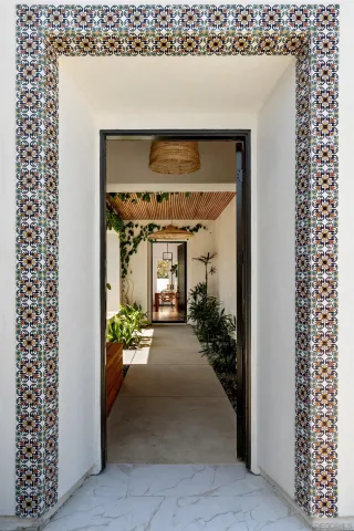 a view of a hallway with a potted plant in front of a door