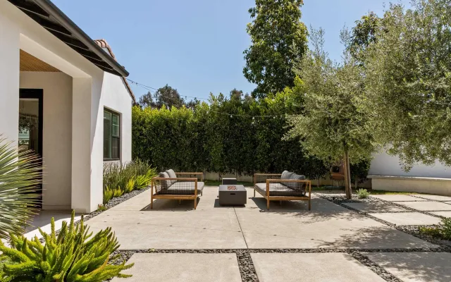 a view of a patio with table and chairs and potted plants