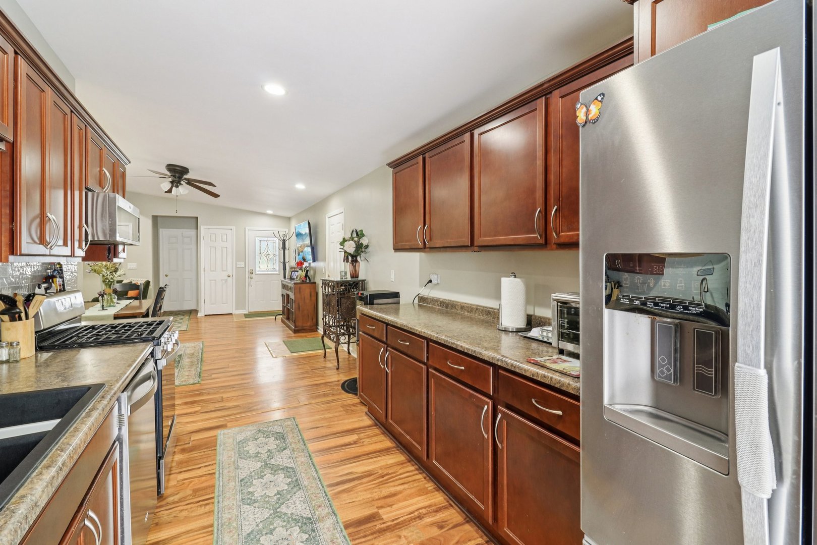 11 Highview Avenue Fox Lake, IL 60020 - Photo 11 of 32 a kitchen with stainless steel appliances granite countertop a refrigerator a sink dishwasher a stove with wooden cabinets and floor
