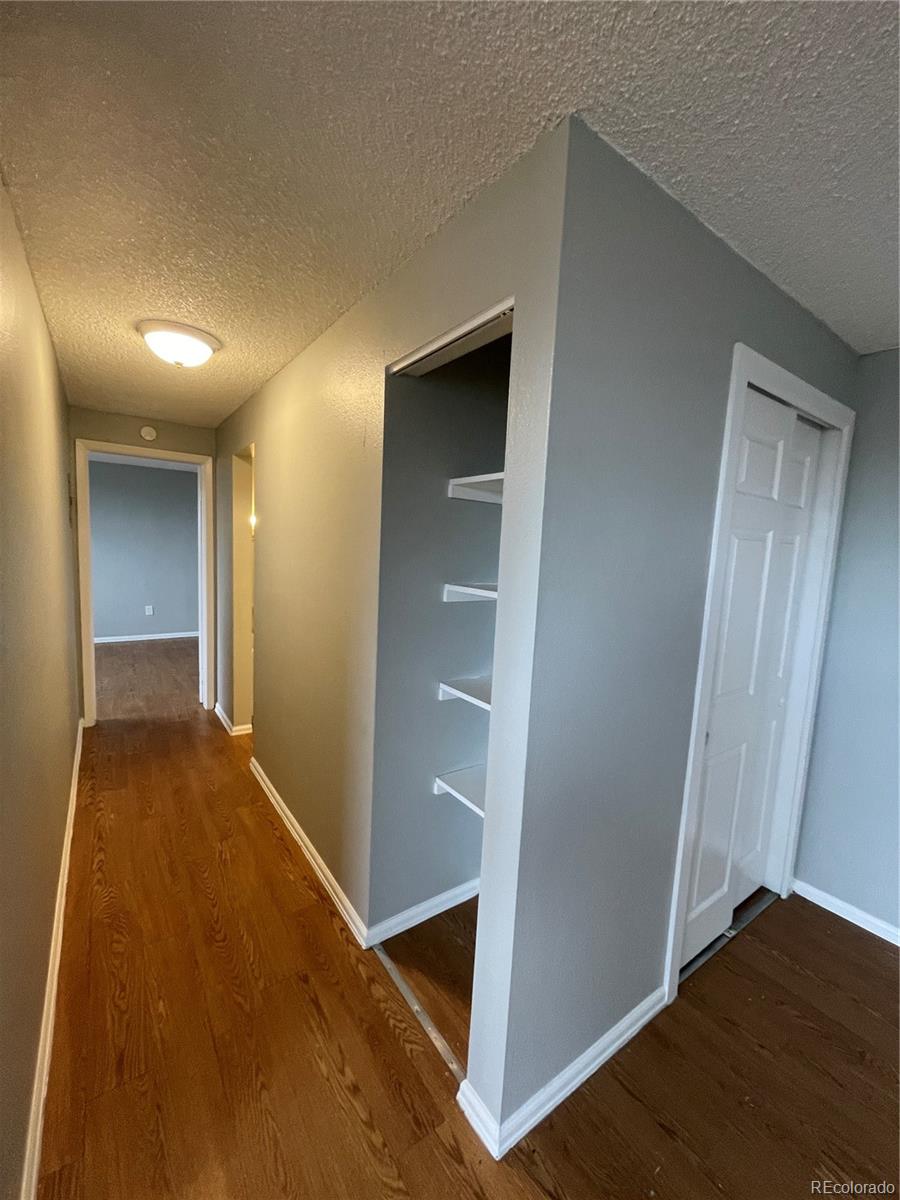1676 Hanover Street, Unit 304 Aurora, CO 80010 - Photo 4 of 11 a view of an empty room and closet area