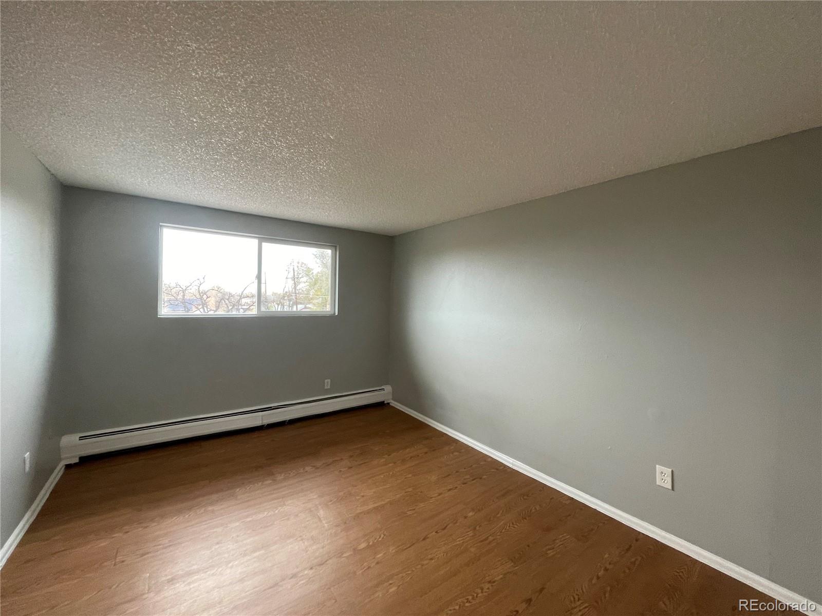 1676 Hanover Street, Unit 304 Aurora, CO 80010 - Photo 7 of 11 an empty room with a window