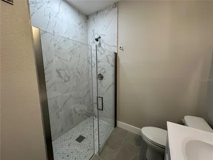 a bathroom with a shower and toilet