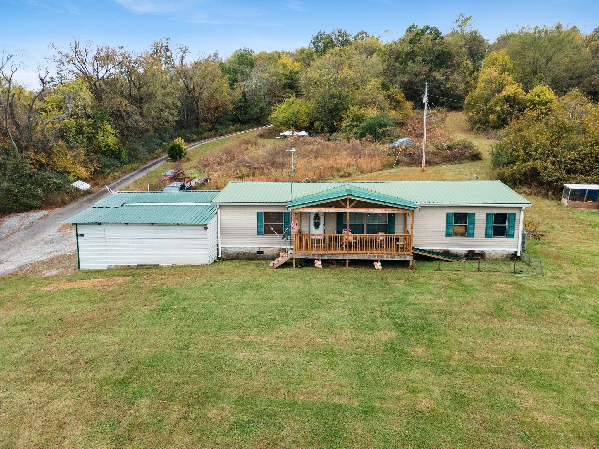 a aerial view of a house with swimming pool next to a yard