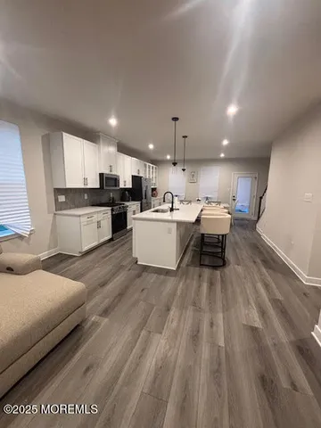 a living room with a couch and a wooden floor