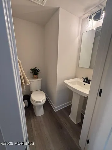 a white toilet sitting next to a bathroom sink