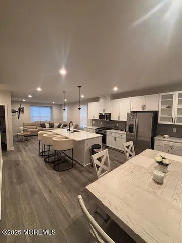 a kitchen with stainless steel appliances kitchen island granite countertop a sink and cabinets