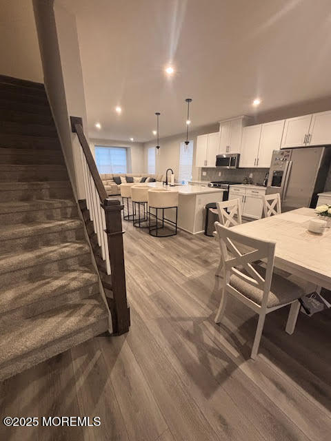1 Halifax Road Bayville, NJ 08721 - Photo 29 of 45 a living room with couches and kitchen view with wooden floor