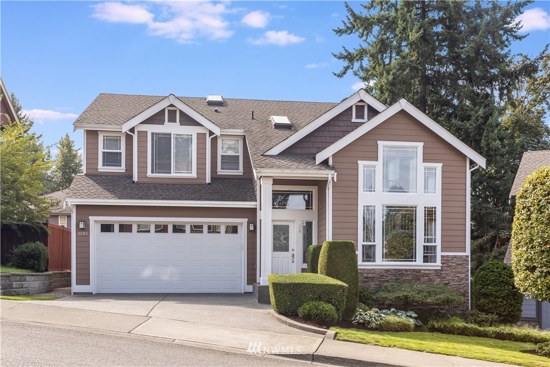 1205 North 27th Place Renton, WA 98056 - Photo 1 of 37 a front view of a house with a yard and garage