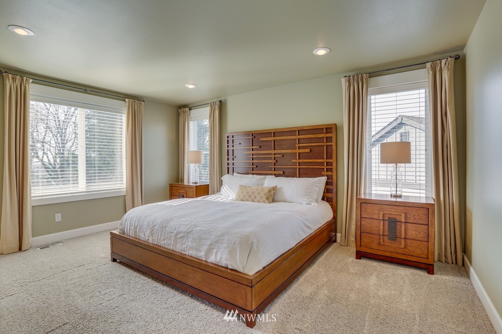 1205 North 27th Place Renton, WA 98056 - Photo 22 of 37 a bed sitting in a spacious bedroom next to a window
