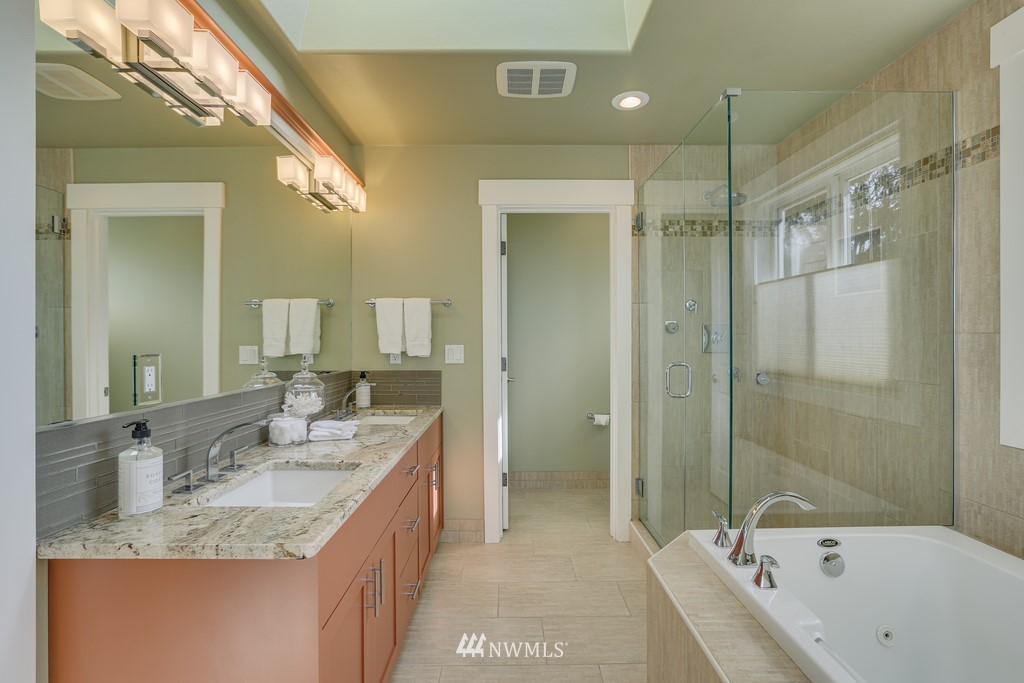 1205 North 27th Place Renton, WA 98056 - Photo 23 of 37 a bathroom with a granite countertop tub sink shower and mirror