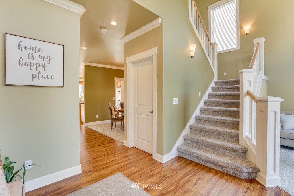 1205 North 27th Place Renton, WA 98056 - Photo 4 of 37 a view of a hallway with wooden floor and staircase