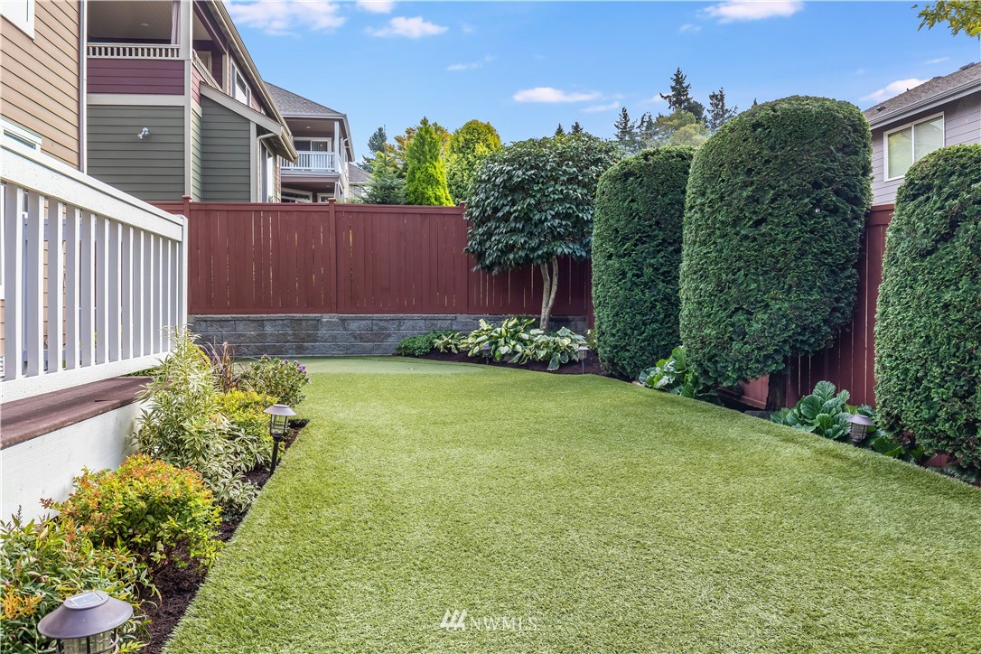 1205 North 27th Place Renton, WA 98056 - Photo 33 of 37 a view of a backyard with plants and large trees
