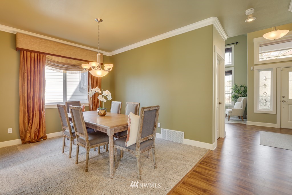 1205 North 27th Place Renton, WA 98056 - Photo 9 of 37 a view of a dining room with furniture window and wooden floor