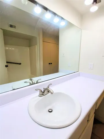 a bathroom with a bath tub with a shower