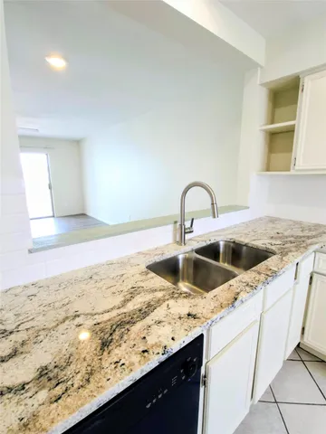 a kitchen with a sink and a stove
